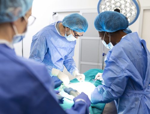 Surgeon team in uniform performs an operation on a patient at a cardiac surgery clinic. Modern medicine, a professional team of surgeons, health.